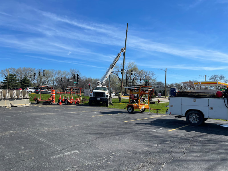 temporary traffic signal pole installation at the southwest corner of Old Orchard Road and Lawler Avenue